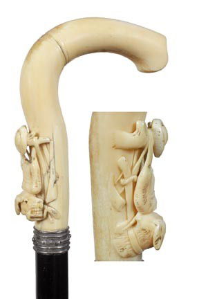 Antique cane and collectable walking stick: 113. A Victorian 5" x 4 ¼" ivory hunting handle, spiked silver collar, ebony shaft, 37" O.L., metal ferrule-$500-$600