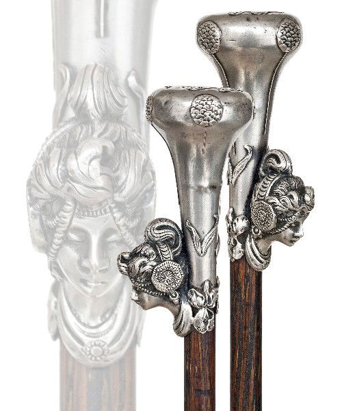 26. Art Nouveau Alphone Mucha Dress Cane-Ca. 1900-: 26. Art Nouveau Alphone Mucha Dress Cane-Ca. 1900- Mushroom shaped silver handle with a female head in the Byzantine style with applied framing floral ornaments, palmwood shaft and a brass ferrule. Au