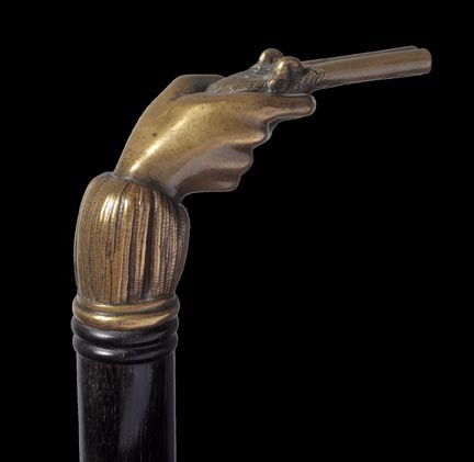 106. Wild West Cowboy Bronze Cane-Circa 1885-A ver: 106. Wild West Cowboy Bronze Cane-Circa 1885-A very finely cast bronze handle with a hand holding a percussion dueling pistol, fine ebony shaft and a brass and metal ferrule-H. 3" x 2", O.L. 36"-$800-
