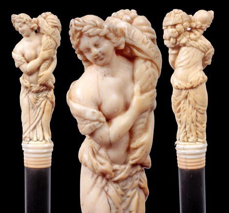 115.Russian Classical Ivory Cane-Circa 1880-A beau: 115.Russian Classical Ivory Cane-Circa 1880-A beautifully carved ivory handle with a lady holding a bundle of flowers with a banner that states "Divrraspaalmaree" ?, ivory ribbed collar, ebony shaft a