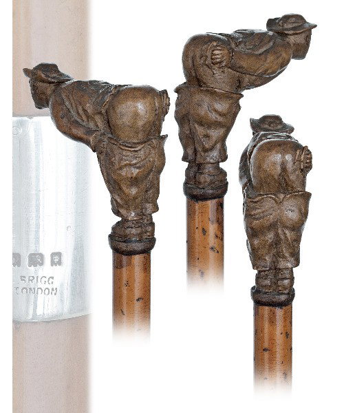129. Brigg Folk Art Cane-Fruitwood handle depictin: 129. Brigg Folk Art Cane-Fruitwood handle depicting a gentleman's morning visit to his favorite outdoor john spot. Full bark malacca shaft , horn ferrule and a plain silver collar with hallmarks and a