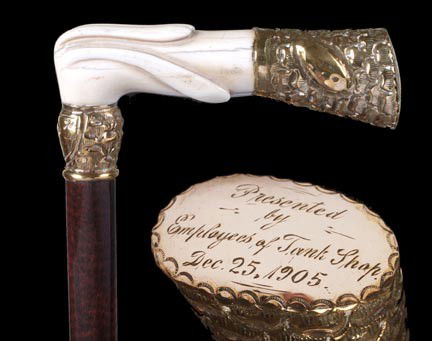 7. Ivory Presentation Cane-Dated 1905-A 5" x 1 ½" ca: 7. Ivory Presentation Cane-Dated 1905-A 5" x 1 ½" carved ivory and gold filled engraved end cap, ornate gold filled presentation collar, rich snake wood shaft and a horn ferrule-O.L. 34"-$400-$600