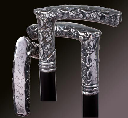 69. Sterling Dress Cane-Dated 1890-A heavy 4" x 3": 69. Sterling Dress Cane-Dated 1890-A heavy 4" x 3" signed ornate sterling handle with various presentations, small silver collar, ebony shaft and a metal ferrule-O.L. 36"-$400-$600