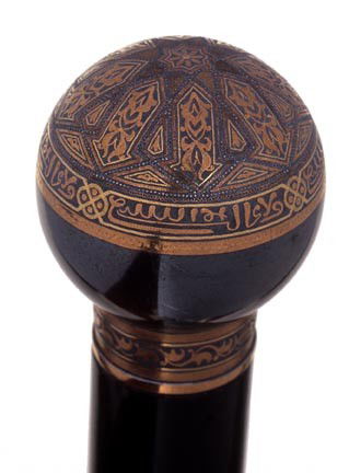 78. Toledo Dress Cane-Early 20th Century-An 1 3/8": 78. Toledo Dress Cane-Early 20th Century-An 1 3/8" sphere with great detailed work, ornate Toledo collar, thick ebony shaft, probably a defensive cane due to its weight and an ebony ferrule-O.L. 36"-$