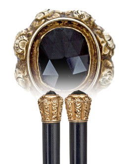Jeweled Gold Feminine Cane-Most likely French, firs: Jeweled Gold Feminine Cane-Most likely French, first half of the 19th Century-Well chased 18 karat yellow gold knob embel­lished with a large, oval and faceted sapphire, ebony shaft and an iron ferru