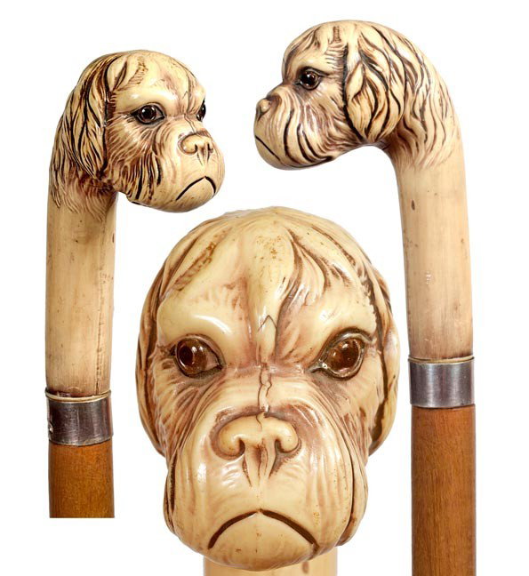 18. Dog Cane-Circa 1900-A carved head with glass ey: 18. Dog Cane-Circa 1900-A carved head with glass eyes possibly meerschaum, sterling hallmarked German collar, oak shaft and a horn ferrule-H. 4 ½" x 2 ½", O.L. 36"-$300-$500