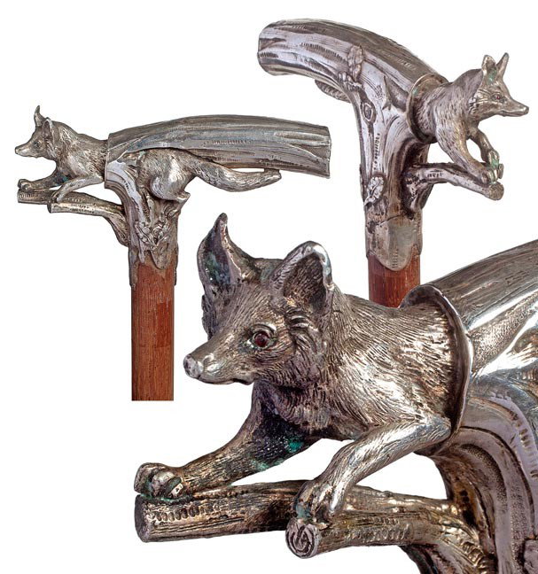 86. Fox Dress Cane-Circa 1885-A .800 silver casting: 86. Fox Dress Cane-Circa 1885-A .800 silver casting with solid fox, ruby eyes, hardwood shaft and a horn ferrule. H. 2 ¾"x 5", O.L. 36"- $500-$1000