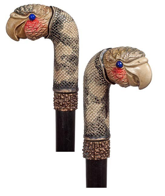 101. Parrot Dress Cane- Circa 1925- A molded and d: 101. Parrot Dress Cane- Circa 1925- A molded and decorated acrylic bird with lapis eyes, bronze collar, ebony shaft and a bi metal ferrule. H. 3 ¾" x 3 ¼", O.L. 34", $300-$500