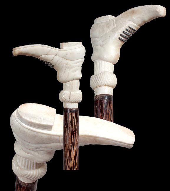 124. Stag High Button Shoe Cane-Circa 1930-A carve: 124. Stag High Button Shoe Cane-Circa 1930-A carved shoe probably out of moose antler, small bone collar, exotic wood shaft and a bone ferrule. H. 3 ¼" x 4", O.L. 36 ¾", $300-$400