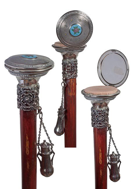 138. Cosmetic/Compact Powder Cane-Circa 1900-An en: 138. Cosmetic/Compact Powder Cane-Circa 1900-An enamel decorated powder box, probably silver, ornate pewter collar, hanging silver hallmarked perfume bottle, malacca shaft and a bimetal ferrule. H. 2 