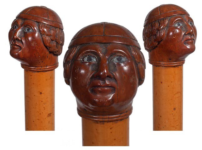 150. Carved Nut Cane-Circa 1880-A carved nut with : 150. Carved Nut Cane-Circa 1880-A carved nut with painted eyes, nice detail, malacca shaft and a stopper ferrule. H. 1 ½" x 1 ½", O.L. 35 ½", $250-$400