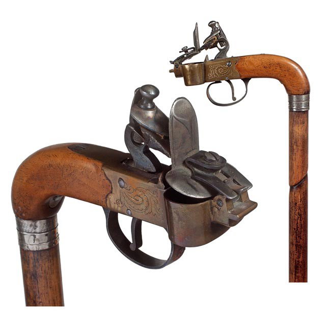 165. Flintlock Cigar Lighter-19th Century-A cigar: 165. Flintlock Cigar Lighter-19th Century-A cigar lighter with its original flint which has been attached by a silver collar to a faux bamboo hardwood shaft and a brass ferrule. H. 5" x 1 ½", O.L. 38