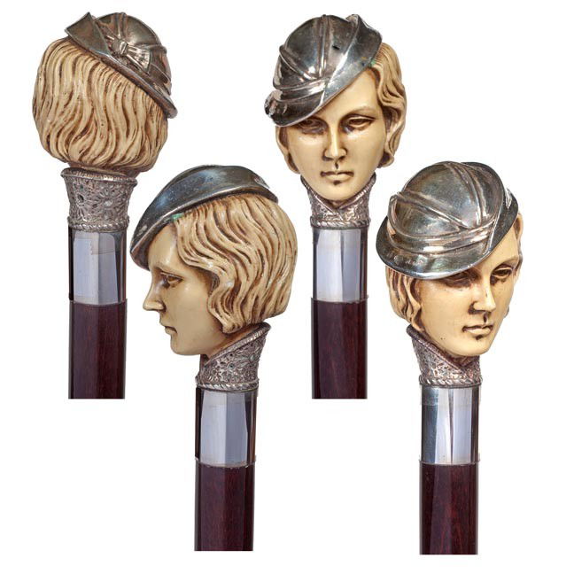 179. Art Deco Flapper Cane-Circa 1930-A hallmarked: 179. Art Deco Flapper Cane-Circa 1930-A hallmarked silver hat on a molded celluloid head, ornate silver collar, exotic wood shaft and a brass ferrule. H. 3 ¾" x 2", O.L. 37 ½", $400-$600