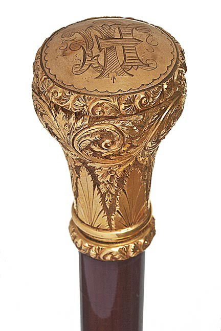 185. Gold Filled Dress Cane-Circa 1900-An ornate d: 185. Gold Filled Dress Cane-Circa 1900-An ornate designed handle and collar, snakewood shaft and a bi metal ferrule. H. 2 ½" x 1 ½", O.L. 36", $300-$500