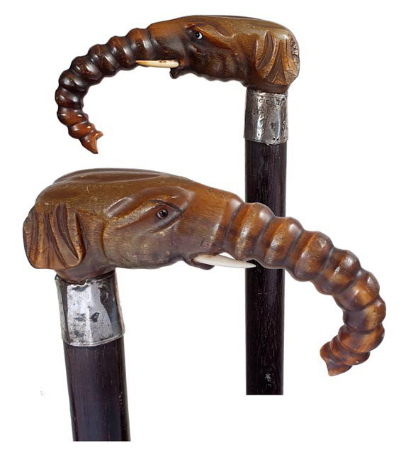 209. Elephant Horn Cane-Circa 1885-A finely carved: 209. Elephant Horn Cane-Circa 1885-A finely carved elephant with two-colored glass eyes and ivory tusk, hallmarked Birmingham silver collar, ebonized shaft and a bi metal ferrule-H. 4 ¼", x 1 ¼", O.