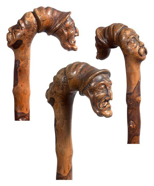 211. Folk Art Carved Cane-Circa 1860-A carved one : 211. Folk Art Carved Cane-Circa 1860-A carved one piece natural branch with two folky faces, twig spur shaft and a metal ferrule-O.L. 34"-$400-$600
