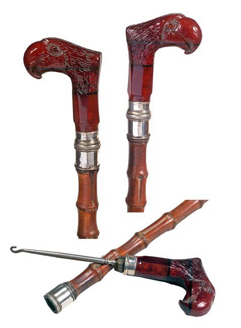 220. Button Hook Cane-Early 20th Century-A carved: 220. Button Hook Cane-Early 20th Century-A carved bakelite or lucite parrot with two-colored glass eyes, British hallmarked silver collar, bamboo shaft and a metal ferrule. H. 3 ¼" x 2 ¾", O.L. 37 �