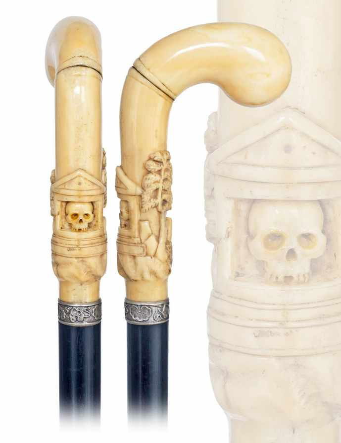 35. Memento Mori Skull Cane-19th Century-Substantial, p: 35. Memento Mori Skull Cane-19th Century-Substantial, pistol shaped walrus ivory handle with a skull, ebony shaft with a white metal collar and worn white metal ferrule. H. 5 ¼" x 3", O.L. 37 ¼"