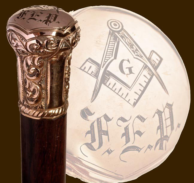 77. Masonic Dress Cane-Circa 1900-An ornate gold filled: 77. Masonic Dress Cane-Circa 1900-An ornate gold filled handle with the Masonic emblem engraved atop, exotic wood shaft and a metal ferrule-H. 2" x 1 ½', O.L. 34 ¼"-