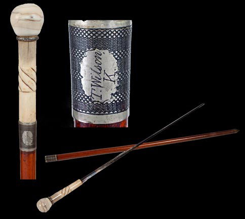 151. Ivory Sword Cane-Mid 19th Century-A walrus ivory h: 151. Ivory Sword Cane-Mid 19th Century-A walrus ivory handle, ornate silver metal spacer, bone handle spacer, 26 ½" 4-sided blued-gilt-acid etched blade, engraved coin silver collar, malacca shaft an