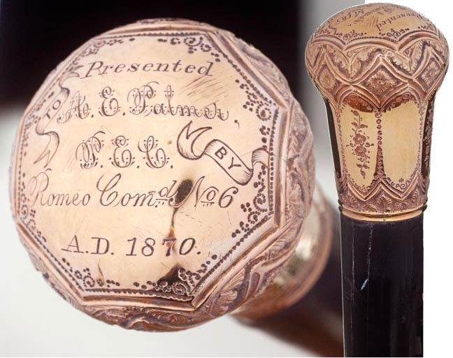 166. Gold-filled Dress Cane-Dated 1870-An ornate handle: 166. Gold-filled Dress Cane-Dated 1870-An ornate handle which is inscribed "Romeo Comd. No. 6", thick ebony shaft and a metal ferrule-H. 1 ½" x 2", O.L. 36 ½"-