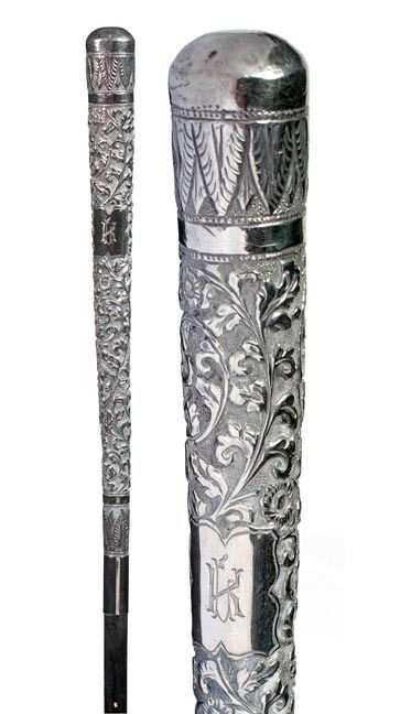 177. Silver Dress Cane-Late 19th Century-A long ornate: 177. Silver Dress Cane-Late 19th Century-A long ornate silver handle in high relief, white metal collar, ebony shaft and a metal ferrule-H. 12 ½" x 1", O.L. 35 ¾"-