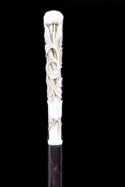 200. Ivory Flower Cane-Late 1900's-An unusual carved iv: 200. Ivory Flower Cane-Late 1900's-An unusual carved ivory handle of an exotic flower with a blank cartouche, small ring ferrule, exotic wood shaft and an ivory ferrule-H. ¾" x 5", O.L. 35 ½"-