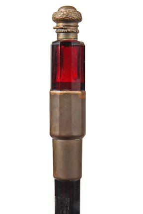 61. Perfume Bottle Cane-Circa 1875-A quality ruby red p: 61. Perfume Bottle Cane-Circa 1875-A quality ruby red perfume bottle with an ornate hinged brass lid, metal collar, ebony shaft and a metal ferrule. H. 5" x 1 ¼", O.L. 35 ½"