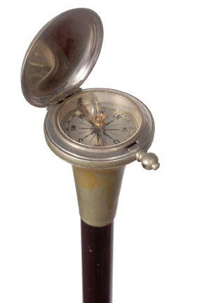 64. Compass System Cane-Early 20th Century-A working wh: 64. Compass System Cane-Early 20th Century-A working white brass spring loaded compass, ebony shaft and a brass ferrule. H. 1 ¾" x 2 ¼", O.L. 35 ¼"