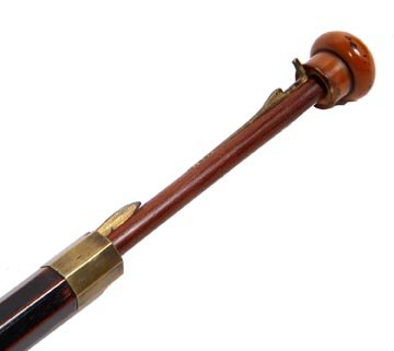 114. Measuring System Cane-Circa 1900-A locking handle : 114. Measuring System Cane-Circa 1900-A locking handle which exposes a small brass instrument, brass hexagonal collar, hexagonal hard wood shaft marked for measuring lumber and a brass ferrule. H. 1" 