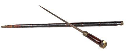 139. Sword Cane-Circa 1860-An ivory and brass handle of: 139. Sword Cane-Circa 1860-An ivory and brass handle of which one section is missing of the ivory, carved eyelets, exotic wood handle and brass collar, 17" forged three sided blade, bamboo shaft and a