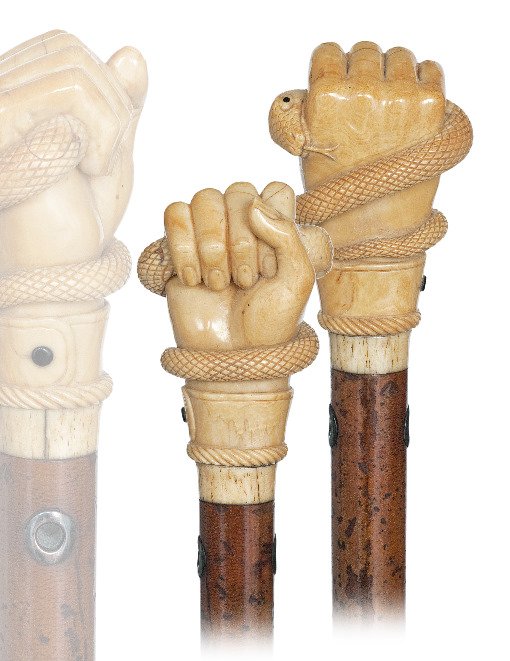 42. Top Rate Marine Cane-Ca. 1840-1850-Substantial whal: 42. Top Rate Marine Cane-Ca. 1840-1850-Substantial whale tooth knob well carved as a fist with a buttoned cuff and a coiled snake with a large head and forked tongue, whalebone collar, malacca shaft w