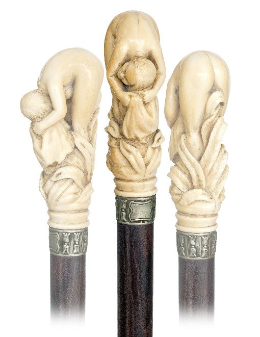50. Ivory Full Nude Dress Cane -Ca. 1890-A carved ivory: 50. Ivory Full Nude Dress Cane -Ca. 1890-A carved ivory bent Venus drying her hair with a great view to the butt. This cane is most likely French, has a white metal collar, a rosewood shaft and a 3 ¼