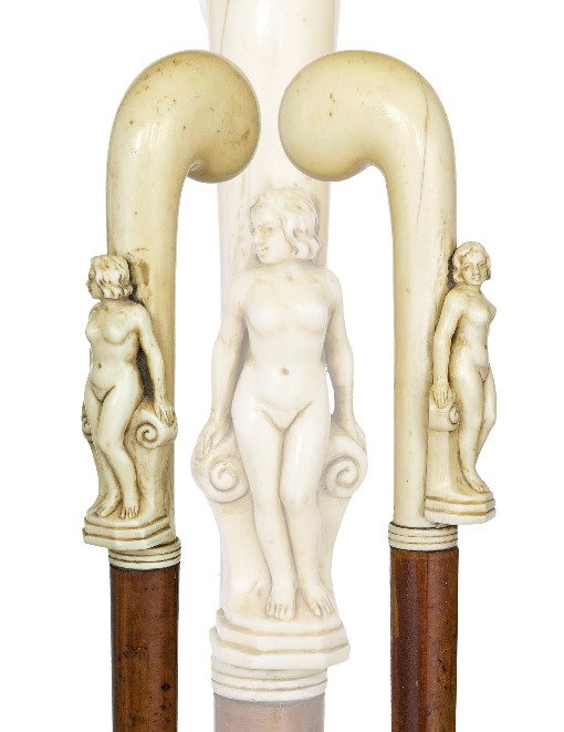 72. German Erotic Micro Carved Ivory Cane-Late 19th Cen: 72. German Erotic Micro Carved Ivory Cane-Late 19th Century-A stretched pistol grip carved ivory handle of a nude Venus , malacca shaft and a long staghorn ferrule.
