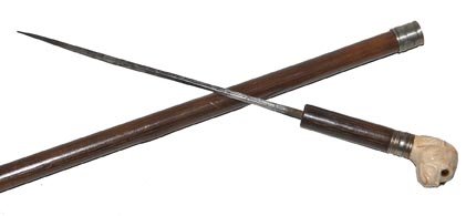 118. Dog Dagger Cane-Ca. 1890-An ivory handle with two : 118. Dog Dagger Cane-Ca. 1890-An ivory handle with two color glass eyes, white metal collar, four sided 7” dagger, stepped wood shaft and a bi-metal ferrule-H. 1 ½” x 1 ½”, O.L. 35-