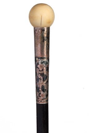 120. Ivory Dress Cane-Ca. 1885-An ivory ball atop, a si: 120. Ivory Dress Cane-Ca. 1885-An ivory ball atop, a silver and copper ornate collar, ebony shaft and a metal ferrule-H. 1” x 1”, O.L. 40”