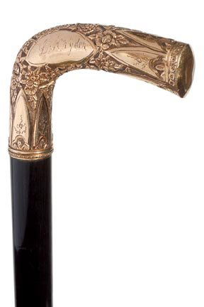 140. Gold Filled Dress Cane-Ca. 1900-An ornate gold fil: 140. Gold Filled Dress Cane-Ca. 1900-An ornate gold filled handle, ebony shaft and a metal ferrule-H. 3 ¼” x 2 ½”, O.L. 34”
