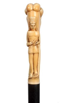 143. Native American Ivory Cane-Early 20th Century-A ca: 143. Native American Ivory Cane-Early 20th Century-A carved ivory handle done in high relief with feather bonnet, ebony shaft and an ivory ferrule-H. 4 ½” x 1 ¼”, O.L. 36”