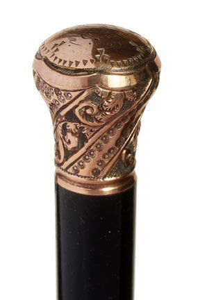 164. Gold Filled Dress Cane-Ca. 1900-An ornate and insc: 164. Gold Filled Dress Cane-Ca. 1900-An ornate and inscribed gold filled handle, ebony shaft and a metal ferrule-H. ¾” x 1”, O.L. 35”-