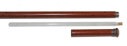 192. Hidden Flask Cane-Ca. 1930-A Tippler’s stick which: 192. Hidden Flask Cane-Ca. 1930-A Tippler’s stick which has both glass flask and a glass hidden within the shaft and handle, unscrewing brass top and a metal ferrule-H. 1 ¼” x 1”, O.L. 35”-
