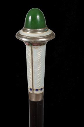 246. Enameled Dress Cane-Ca. 1900-An enamel dress handl: 246. Enameled Dress Cane-Ca. 1900-An enamel dress handle with a large jade stone atop, hallmarked probably French 900 silver collar, ebony shaft and a metal ferrule-H. 1 3/8” x 3”, O.L. 36”-