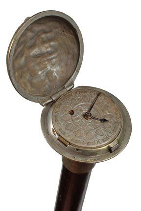 255. Key Wind Pocket Watch Cane-Mid 19th Century-A sign: 255. Key Wind Pocket Watch Cane-Mid 19th Century-A signed London dial which is key wind and set, bell bronze ornate watch case with locking mechanism, white metal collar, ebony shaft and a bone ferrul