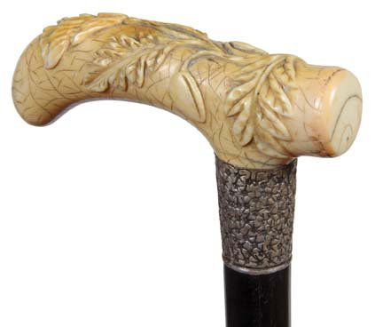 9. Floral and Berry Ivory Cane- Ca. 1880- A large handl: 9. Floral and Berry Ivory Cane- Ca. 1880- A large handle carved in high relief, very ornate silver metal collar, thick ebony shaft and a metal ferrule. H. 5” x 1 ¾”, O.L. 36 ¼”