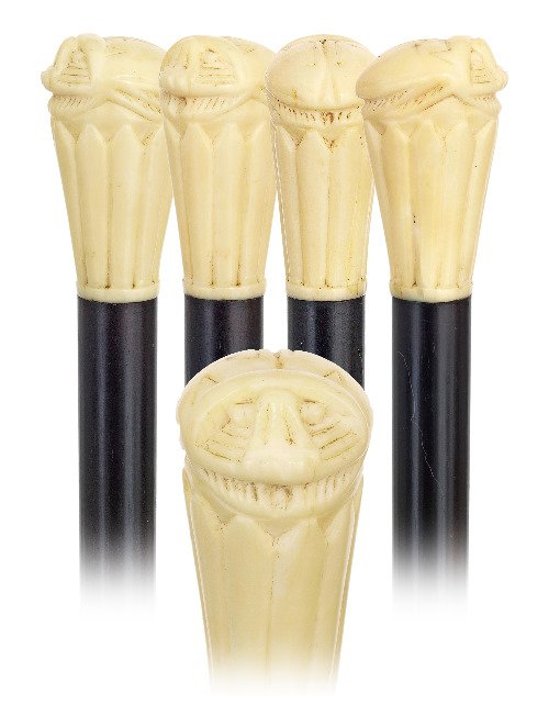 144. Revival Ivory Cane -Ca. 1910-Ivory scarab on an in: 144. Revival Ivory Cane -Ca. 1910-Ivory scarab on an integral ribbed plinth, ebony shaft with an ivory ferrule. Anglo-Egyptian cane from period of the great Pharaonic excavations discoveries of early