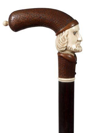 231. Ivory and Wood Dress Cane-Ca. 1885-A well executed: 231. Ivory and Wood Dress Cane-Ca. 1885-A well executed carved wood and ivory bearded gentleman handle with two color glass eyes, ivory collar, ebony shaft and a horn ferrule-H. 4" x 3 ½", O.L. 35 ¾