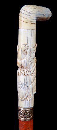2. Ivory Eagle Dress Cane-Ca. 1885-A handsome carved iv: 2. Ivory Eagle Dress Cane-Ca. 1885-A handsome carved ivory eagle with two 12 star flags, ornate gold-filled collar, malacca shaft and a 2” horn ferrule-H. 4” x 5”, O.L. 35”-