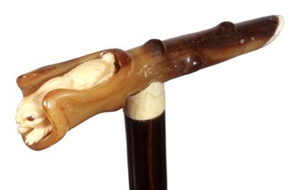 127. Rabbit Dress Cane-Ca. 1930-A carved ivory rabbit w: 127. Rabbit Dress Cane-Ca. 1930-A carved ivory rabbit with two color glass eyes which is resting in a carved horn log, ivory collar, rich ebony shaft and a horn ferrule-H. 5 ½” x 1 ¼”, O.L. 34��