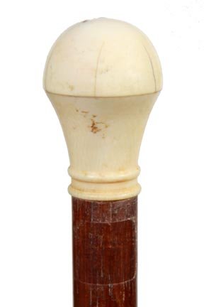 179. Ivory Sewing System Cane-Ca. 1900-A sewing compart: 179. Ivory Sewing System Cane-Ca. 1900-A sewing compartment cane which holds 3 ivory bobbins, ivory thimble and a needle, walnut shaft and a metal ferrule. H. 1 ½” x 2”, O.L. 36”-