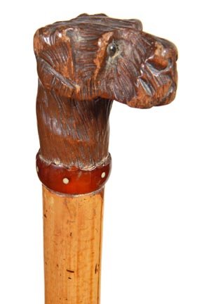 192. Carved Terrier Dog Cane-Ca. 1930-A carved Black Fo: 192. Carved Terrier Dog Cane-Ca. 1930-A carved Black Forest dog with two color glass eyes, with minor chips on ear, bakelite polka dot collar with chipping, thick malacca shaft and a metal ferrule. H.