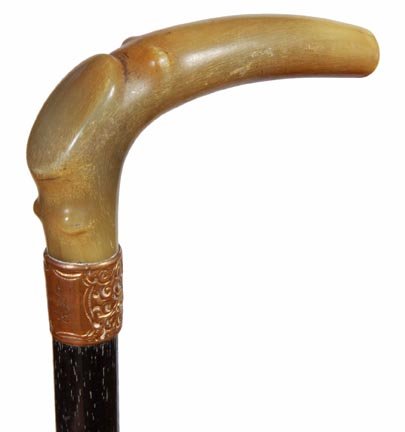193. Horn Dress Cane-Ca. 1885-A nicely formed horn hand: 193. Horn Dress Cane-Ca. 1885-A nicely formed horn handle which is fitted for the left hand, ornate gold-filled presentation collar, ebony shaft and a metal ferrule-H. 4 ½” x 2 ½”, O.L. 35”-